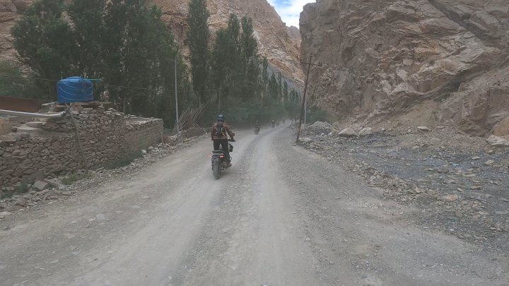 Rider in blue jacket on a motorcycle