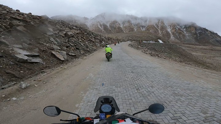 Rider in green jacket on a motorcycle