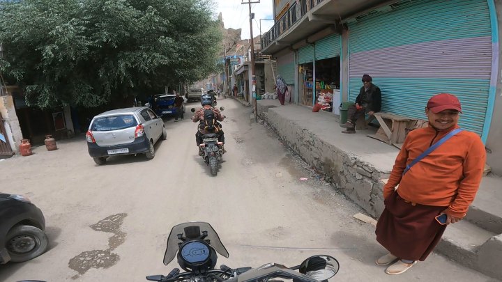 Rider in orange jacket on a motorcycle
