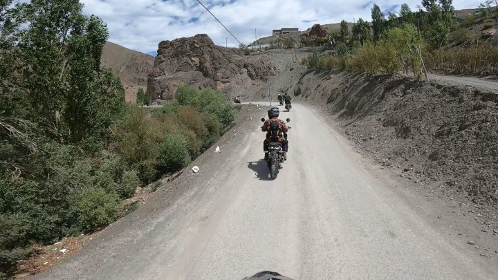 Rider in orange jacket on a motorcycle