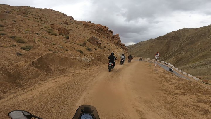 Rider in tan jacket on a motorcycle