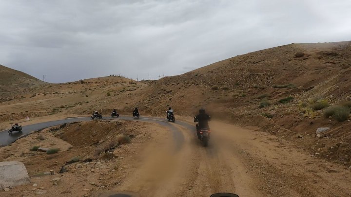 Rider in tan jacket on a motorcycle